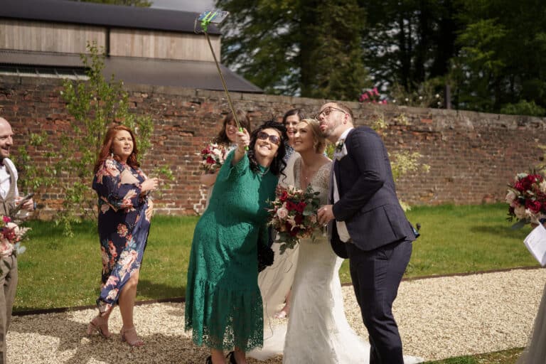 a bride and groom happily capturing a selfie at their wedding in the stunning settings of foxtail barns.