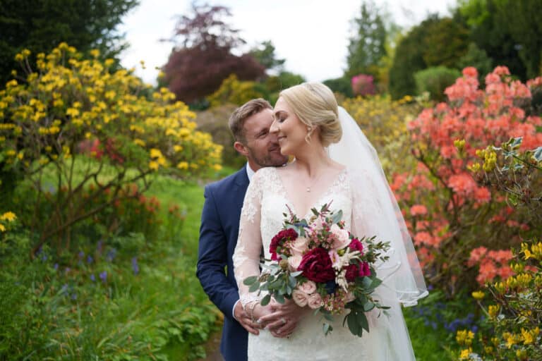 a bride and groom embracing in a garden at foxtail barns.