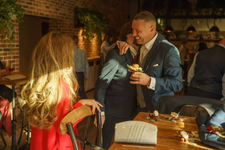 a man in a suit and a woman in a red dress are having a drink at foxtail restaurant.