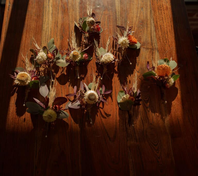 a bunch of foxtail flowers on a wooden table.