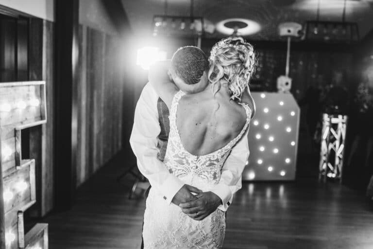 a bride and groom hugging during their first dance at foxtail barns.