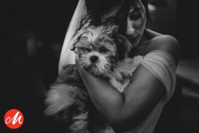 a black and white photo of a woman hugging a dog, captured by pbartworks photography.