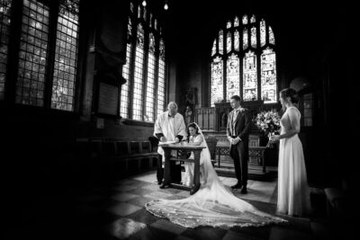 black and white photo of bride and groom in a church captured by a skilled wedding photographer in shropshire.