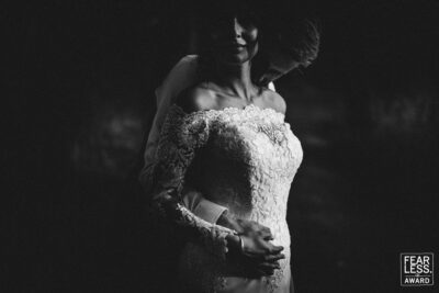 a bride and groom embracing in the dark, captured beautifully by a wedding photographer in shropshire.